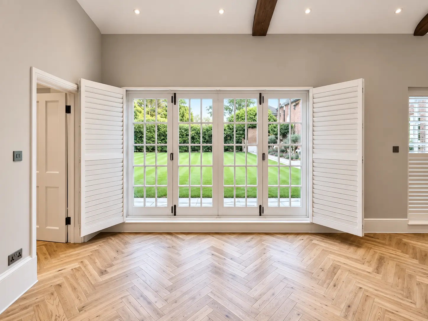 Full-height games-room shutter panels opened beside the glazing in the Esher display house.