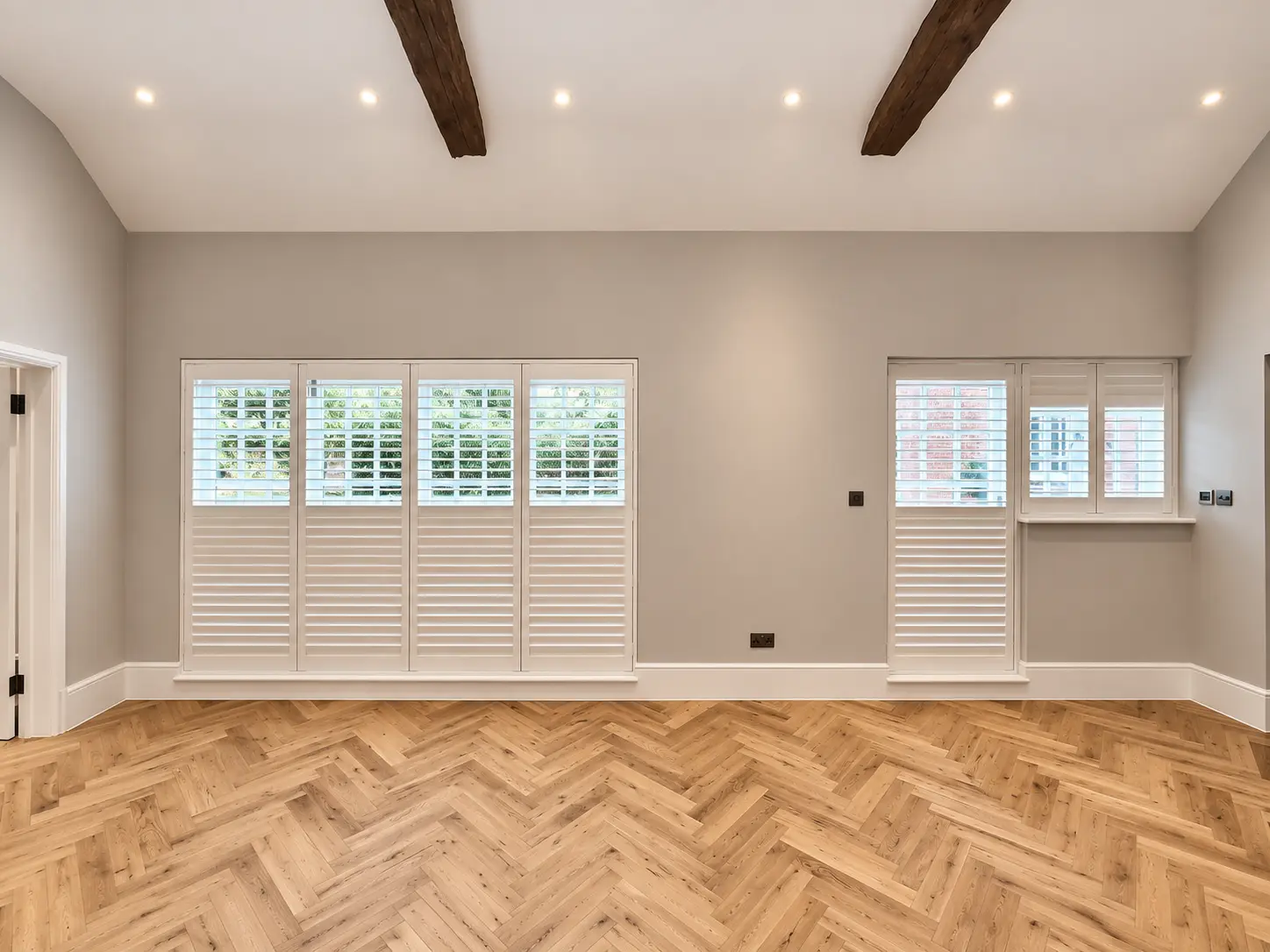 Full-height games-room shutter panels closed with the upper louvres open in the Esher display house.