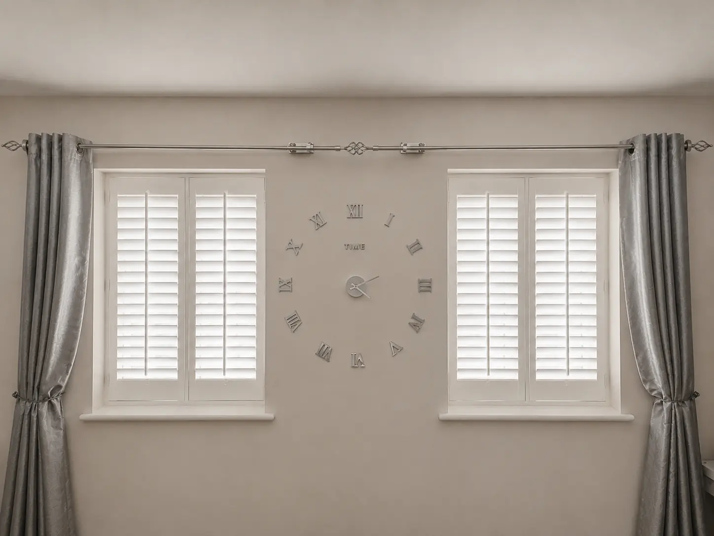 White full-height shutters with closed louvres at two living-room windows, with a wall clock between them.