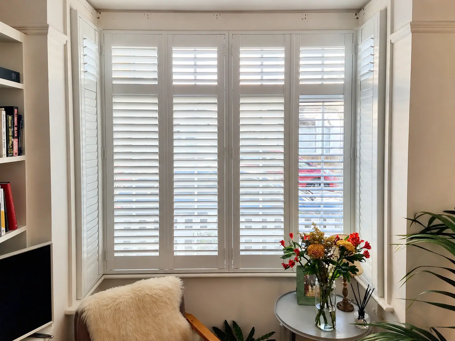 Full-height plantation shutters fitted in a Kingston living-room bay window.